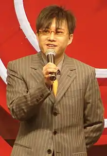 Albert Leung holding a microphone