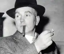 Pierrepoint, wearing a hat, and about to light a cigar