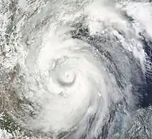 Satellite imagery of a mature hurricane progressing west-northwest towards the coastline of Mexico.