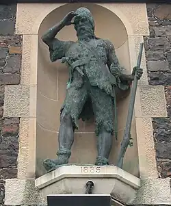 Bronze statue of Selkirk located in a stone alcove