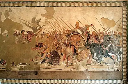 A large mosaic depicting an array of soldiers on horseback doing battle. Parts of it have been damaged or lost to time.