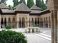 Court of the Lions in 2003, before most recent restoration. Most of the floor was occupied by beds of gravel. The domed roof and the fountain upper sections were removed in the 20th century.