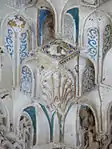 Extreme close-up of carved and painted details in constituent niches of a muqarnas dome in the Sala de los Reyes in the Alhambra