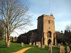 Stone building with square tower.