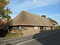 Great Tree Farm Barn, a weatherboarded and thatched 17th-century barn on London Road