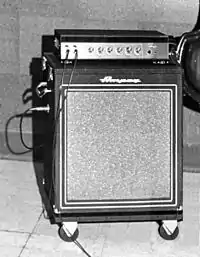 A 1950s era amplifier unit sitting on top of a bass speaker cabinet.