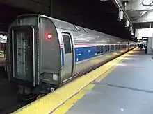 A row of stainless steel cars at a station