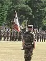 Colonel Launois in front of the regimental colors of the 2e RIMa.