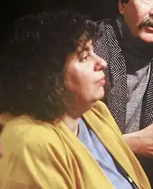 Dworkin seated and turning toward the camera