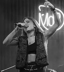 black-and-white image of Angelina Mango singing onstage