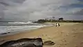 Surfers at Angourie Point on a cloudy day