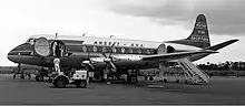 An aircraft pictured standing on the apron at an airport