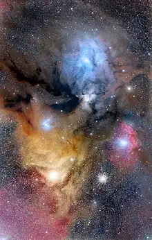 Rho Ophiuchi Region, with the main dark nebula Lynds 1688 (and further L1689) to the left, ρ Ophiuchi at the center of the large blue area (IC 4604), Antares in the large yellow area and Sigma Scorpii in the redish Sh2-9 area, with Messier 4 inbetween the latter two stars. North is up. July 2, 2019 photo by Adam Block.