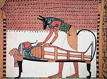 Image 18Anubis, the god associated with mummification and burial rituals, attending to a mummy. (from Ancient Egypt)