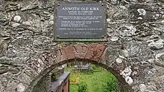 A stone arch with a plaque above it