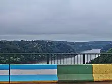 The border between Argentina (Puerto Iguazú) and Brazil (Foz do Iguazú) on the Iguazú River. Paraguay (Ciudad del Este) is in the background.