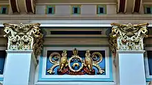 Two internal pillar tops and a relief of the city arms, featuring owls