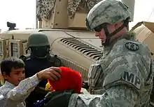 A soldier with the SSI of the 89th Military Police Brigade on his Interceptor Body Armor shoulder pad.