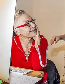 Barbara Hammer facing to the right, wearing a red shirt