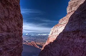 view of high desert through a mountain crevasse