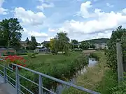 The park in the middle of the city with the Messancy river.