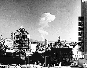 Image 56This view of downtown Las Vegas shows a mushroom cloud in the background. Scenes such as this were typical during the 1950s. From 1951 to 1962 the government conducted 100 atmospheric tests at the nearby Nevada Test Site. (from Nuclear weapon)