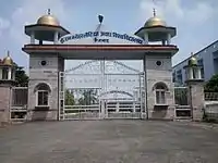 Four-story, round, light-coloured building