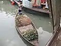 A boatman sells pineapples at Sadarghat on the Buriganga