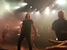 Between the Buried and Me performing in August 2018From left to right: Paul Waggoner, Tommy Giles Rogers Jr., Blake Richardson, Dan Briggs, Dustie Waring