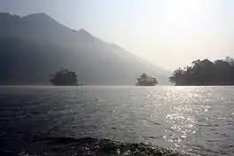 A lake with islands and sides all covered in trees