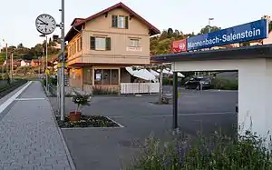 Platform shelter with three-story building in the background