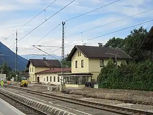 Pair of two-story building with gabled roofs joined by single-story section