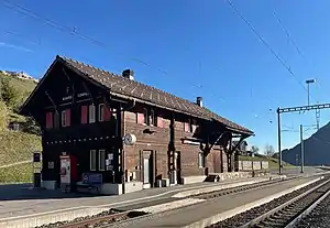 Two-story wooden building with gabled roof