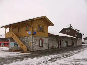 Two two-story stone buildings joined by a single-story connection