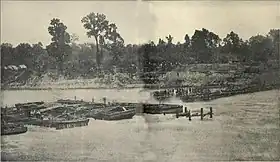 Sepia toned photo shows a river with obstructions in it.