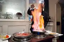 A waiter prepares Bananas Foster at Brennan's