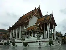 Large Buddhist temple, with a statue of a horse outside