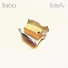 A stick of butter with a single fly atop it, along with the album's title and the word "Barbra".