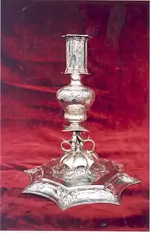 Sterling silver candlestick, One of a pair of candlesticks made for the 5th Earl of Bath's widow. Marks for silversmith Robert Cooper, London, and 1679. They bear the arms of the widow of the 5th Earl of Bath.