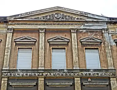 Detail of the pediment and the upper facade