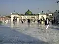 The shrine surrounds the green-domed tomb