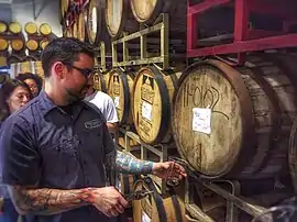 Image 50A beer sommelier tapping a barrel for a taste at Nebraska Brewing Company (from Craft beer)