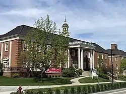 Building with central cupola and wings with Greek-style columns