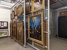 In museums, paintings, framed and unframed, are normally hung on sliding or fixed racking.