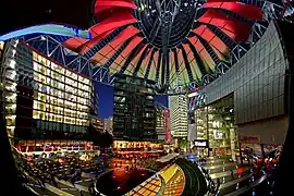 Interior view of Sony Center atrium, Berlin, 2000 by Helmut Jahn, during artificial sunset sequence; lighting design Yann Kersalé