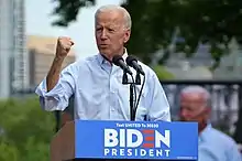 Photo of Biden raising his fist while while standing behind a lectern