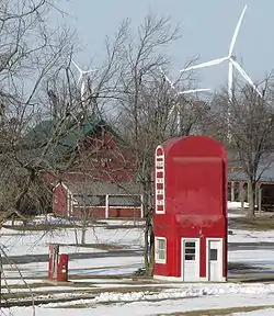 Suzlon WTGs behind a vintage gas pump at the Bluegrass Ridge Wind Farm in King City, Missouri