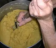 Mixing choux pastry dough for beignets