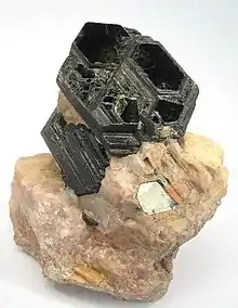 Image 15Perfect basal cleavage as seen in biotite (black), and good cleavage seen in the matrix (pink orthoclase). (from Mineral)