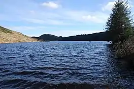 A lake surrounded by hills and trees